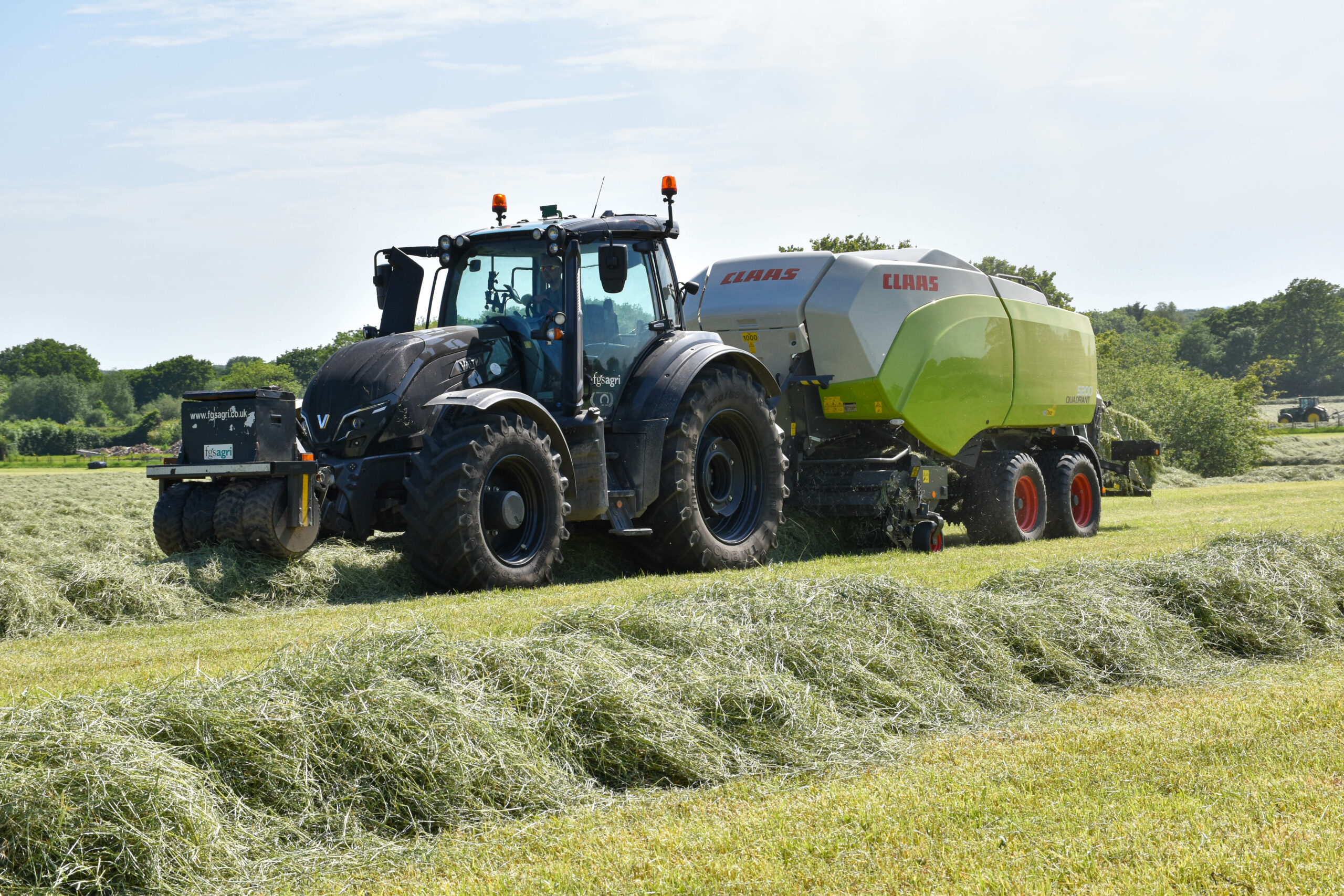 Valtra tractor square baling with Claas Quadrant baler